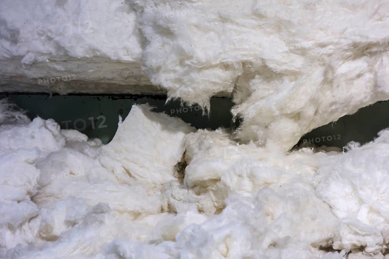 Close up of harvested, raw, untreated cotton fibres in cotton mill