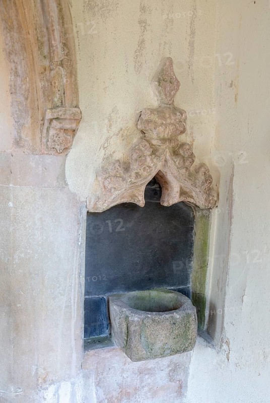 Holy water stoup bowl in porch entrance, village parish church of St James South Elmham, Suffolk, England, UK