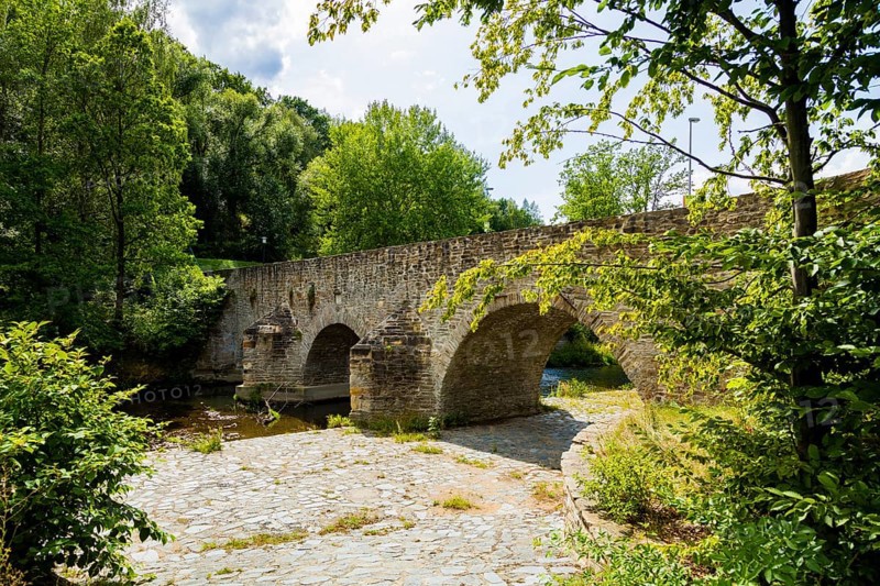 Old Mulde Bridge Stone Bridge Built in 1501 Next to the normal village road, hikers and cyclists will find a historic stone bridge. The old Mulde bridge next to the concrete bridge was built in 1501. It replaced the wooden footbridge of the oldest Dresden country road, Halsbrücke, Conradsdorf, Saxony, Germany, Europe