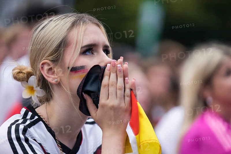 A woman watches the football match in the fan zone at the Brandenburg Tor during the quarter-final match between Germany and Spain at the European Football Championship, Berlin, 05/07/2024