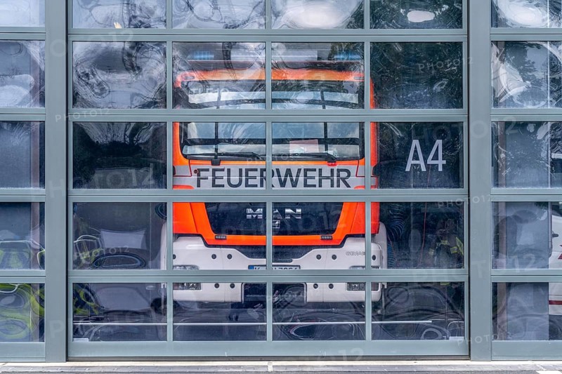 Fire brigade, fire station, modern fire station, glass Tor tor, emergency vehicles in the vehicle hall, Cologne, North Rhine-Westphalia, Germany, Europe