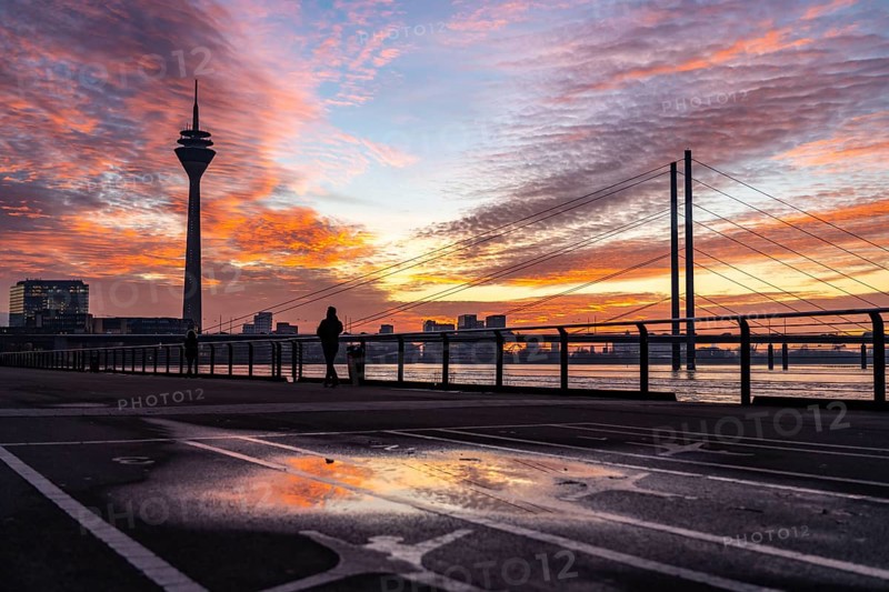 Winter sunset on the Rhine near Düsseldorf, riverside promenade at the old town, Rhine Tower, cargo ship, Rheinkniebrücke, North Rhine-Westphalia, Germany, Europe