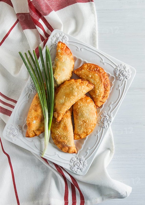 Fried chebureks, close-up, on a light background, no people