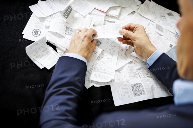The subject of taxes. A man holds receipts in his hand in Berlin, 09/08/2024