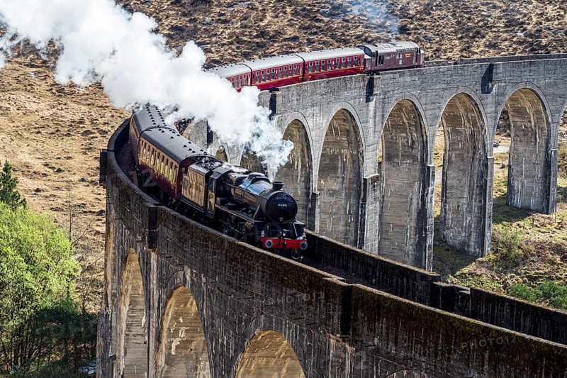 Jacobite steam train at the Glenfinnan viaduct, scottish highland, Scotland, UK