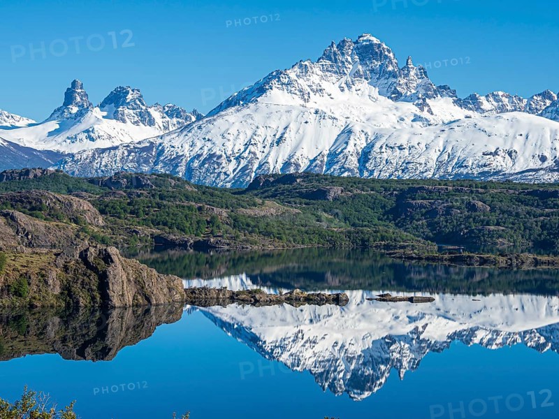 The snow-covered Mt. Cerro Castillo is reflected in a lake, Patagonia, Chile, South America