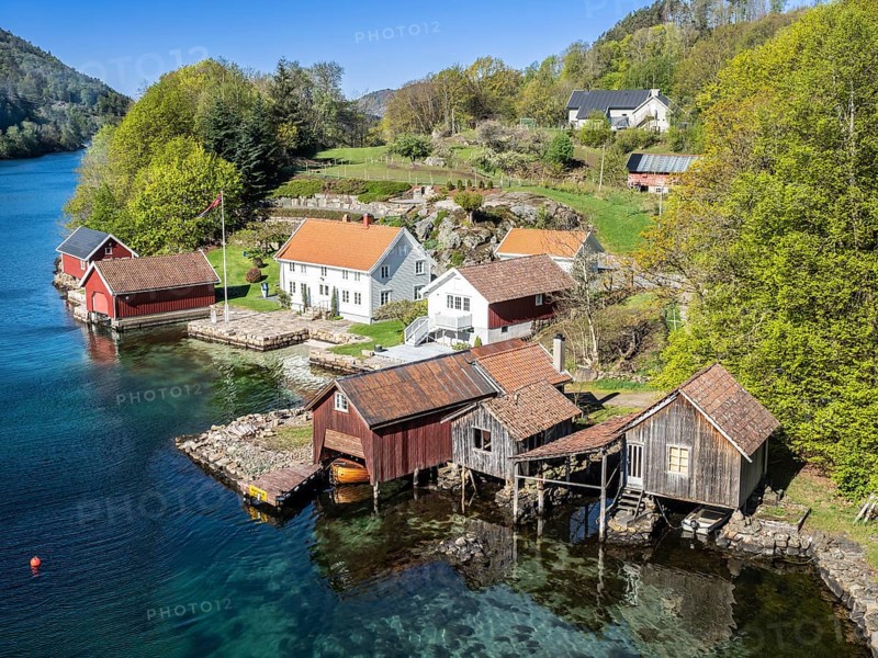 Typical red and white wooden norwegian house, near Cape Lindesnes at the Lenefjord, Norway, Europe