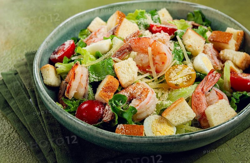 Caesar salad, with tiger prawns, shrimp salad, lettuce, quail eggs, cherry tomatoes, parmesan cheese, no people
