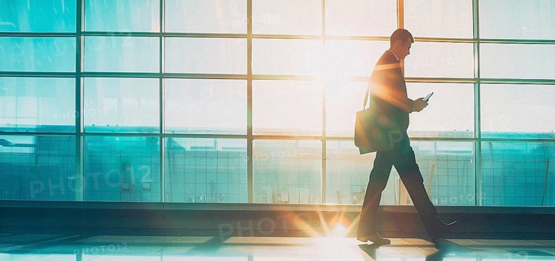 Passenger businessman in modern international airport waiting for plane departure, AI generated
