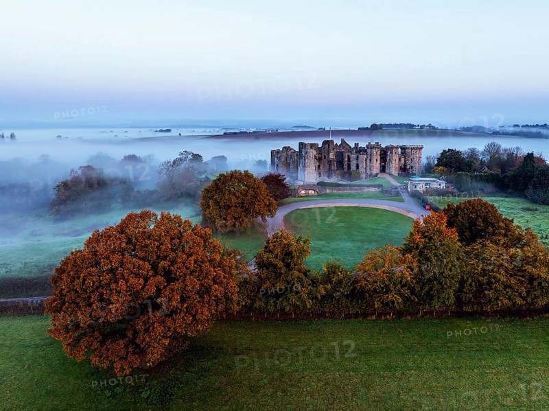 Raglan Castle in the fog at dawn from a drone, Monmouthshire, Wales, England, United Kingdom, Europe