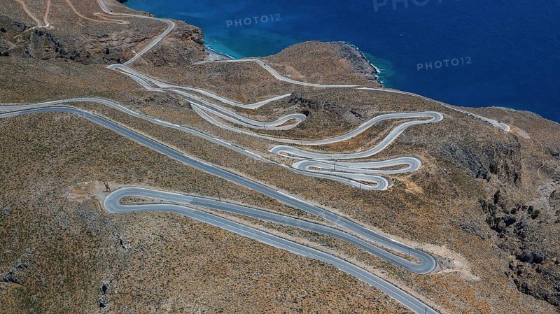 Aerial view of pass road serpentines from to Passo Anopoli above south coast of Crete right Libyan Sea Mediterranean Sea near Sfakia, Chora Sfakion, Crete, Greece, Europe