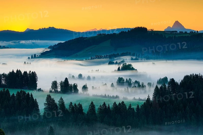 Dawn with a view from the Raten Pass over the fog-covered high moor of Rothenthurm in the canton of Schwyz, Switzerland, Europe