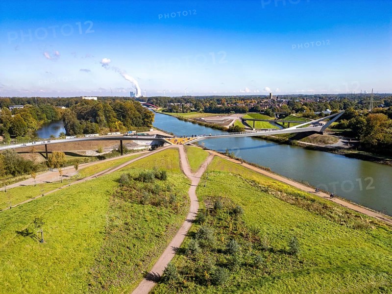 New bridge over the Rhine-Herne Canal and the Emscher, leap over the Emscher, bicycle and pedestrian bridge, 412 metres long, at the so-called Emscherland, Castrop-Rauxel water cross, background: UNIPER coal-fired power station Datteln 4, North Rhine-Westphalia, Germany, Europe