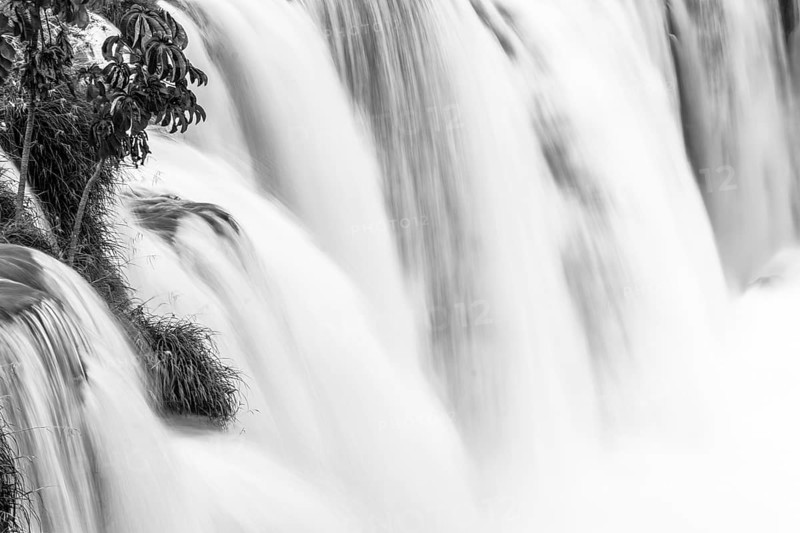 B&W landscape photo of falling water over the edge of the water fall. Long exposure image of flowing water. Victoria Falls, Zimbabwe, Africa