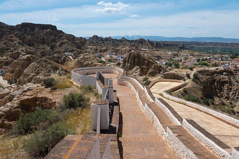 Panoramic view of a mountainous landscape with winding paths and a wide horizon under a summer sky, Mirador del Cerro de la Bala, cave district, Troglodytos, Barrio de Cuevas, Guadix, Granada province, Andalusia, Spain, Europe