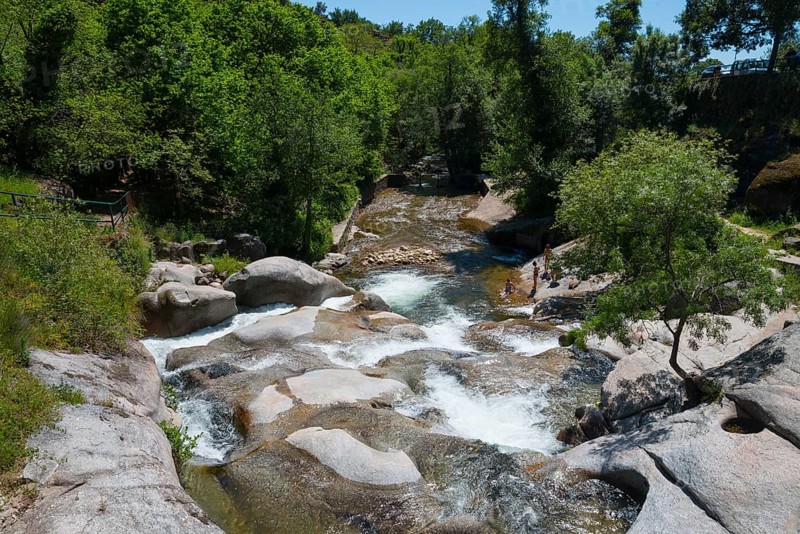 A tranquil river flows through a rocky landscape surrounded by lush green trees, natural pool, Garganta la Olla, Sierra de Tormantos, Cáceres, Caceres, Extremadura, Spain, Europe