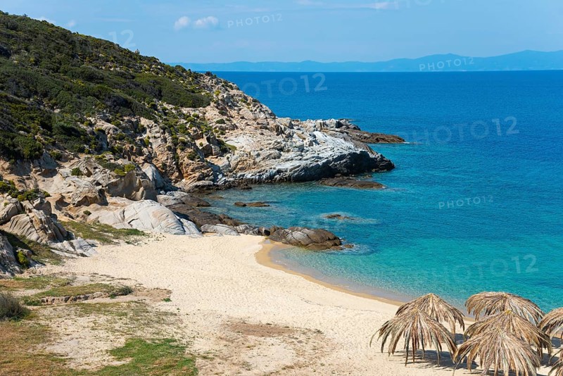 Lonely coastal landscape with clear water, rocky shores and a quiet beach under a blue sky, beach, Kriaritsi, Sithonia, Chalkidiki, Central Macedonia, Greece, Europe