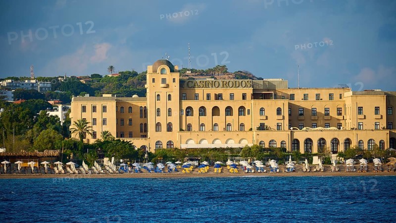 Casino building on the beach with parasols and clear sea, harbour area, Rhodes Town, Rhodes, Dodecanese, Greek Islands, Greece, Europe