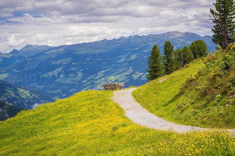 Hiking trail to a bench with a marvellous view of the mountains and surrounding meadows, Penken, Zillertal. Austria