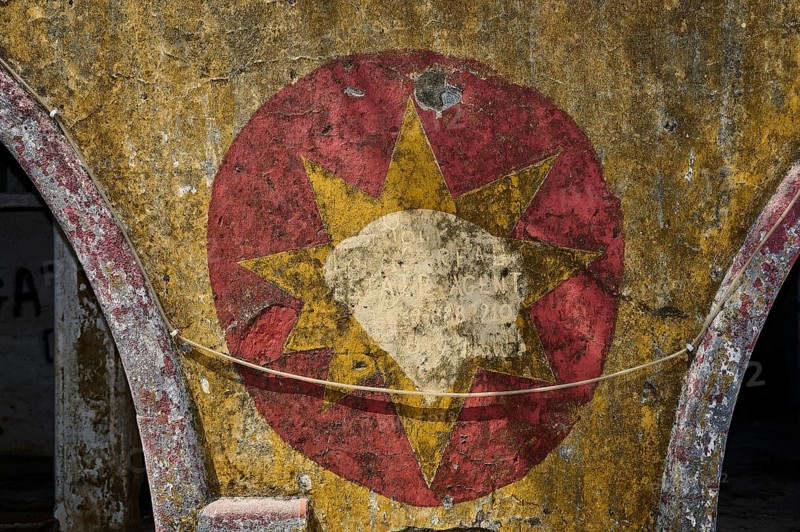 Worn mural of a star symbol with faded red and yellow tones, surrounded by peeling old plaster and light graffiti, Italian Governor's Palace, Ruins, Italian colonial settlement, Eleousa, Rhodes, Dodecanese, Greek Islands, Greece, Europe