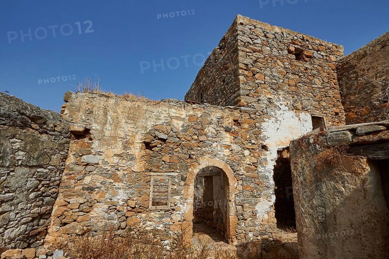 Abandoned stone houses and ruins under a clear blue sky on a sunny day, Venetian Sea Fortress, Leper Island, Spinalonga, Elounda Bay, Mirabello Bay, East Crete, Crete, Greek Islands, Greece, Europe