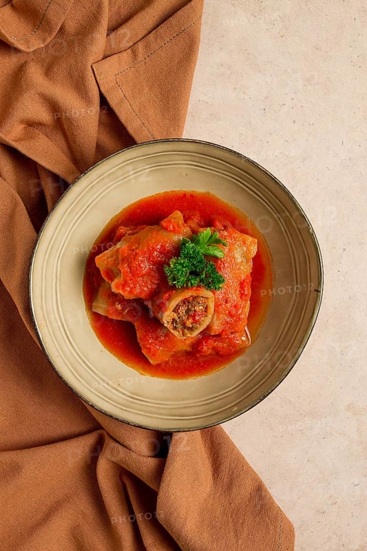 Stuffed cabbage rolls, with minced meat, in tomato sauce, on a beige background, food and drink, healthy eating, healthy lifestyle, cuisine, rustic, cabbage roll, top view, no people
