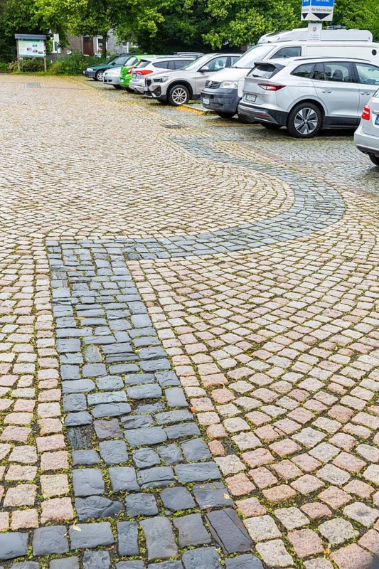 Remains of a historic church in Romanesque style with original vestibule made of natural stone from 1822, To the east, opposite the Imperial House, stood the east-west orientated collegiate church of St Simon and Judas, of which only the northern vestibule has survived. The floor plan of the collegiate church is incorporated into the paving of the car park located there today, Cathedral vestibule, Goslar, Lower Saxony, Germany, Europe