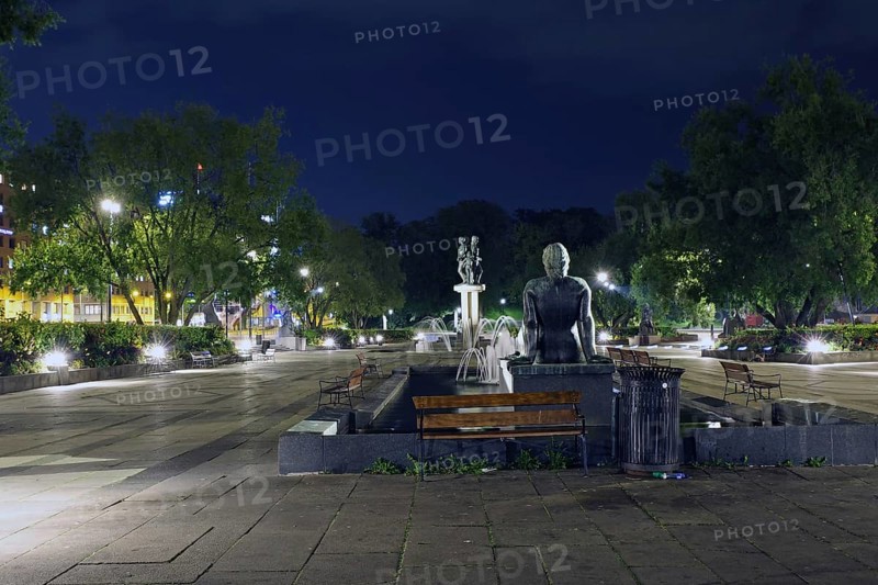 City square illuminated at night with fountain, statues and surrounded by trees and benches, square in front of the city hall, Nobel Peace Prize, Oslo, Norway, Europe