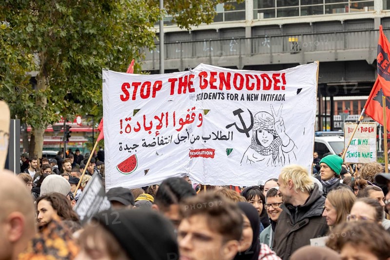 Banner Stop the Genocide! Students for a new Intifada at the pro-Palestinian demonstration in Berlin, Germany, 6.10.2024: Pro-Palestinian demonstrators protest at Kottbusser Tor in Berlin-Kreuzberg under the slogan Demo against genocide in Gaza on the anniversary after radical Islamist Hamas attacked Israel on 7 October 2023, killing over 1, 000 people and kidnapping hundreds in the Gaza Strip, which has been at war with Israel ever since. Berlin, Europe