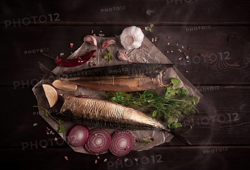 Smoked mackerel, top view, with spices, on a wooden table, no people, selective focus