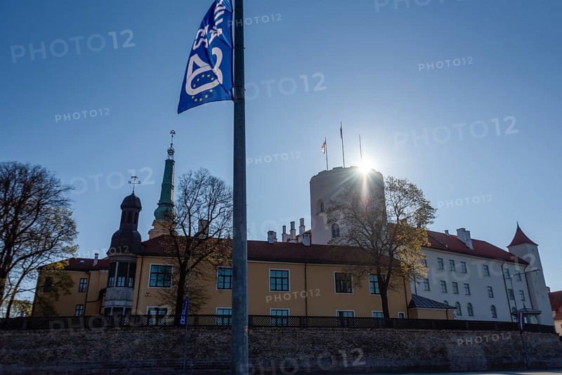 Flag to mark the 20th anniversary of Latvia's accession to the EU, behind it Riga Castle, seat of the Latvian President, Riga, Latvia, Europe
