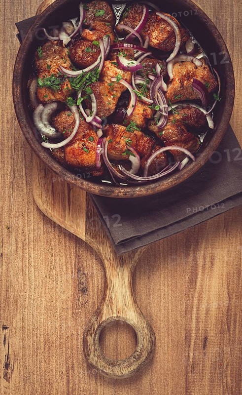 Fried meat, pork kebab, ketsi in a clay pan, with red onions and herbs, homemade, no people