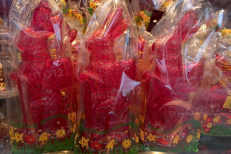 Red rabbit figurines wrapped in cellophane, in the shop window of a confectionery, Bavaria, Germany, Europe