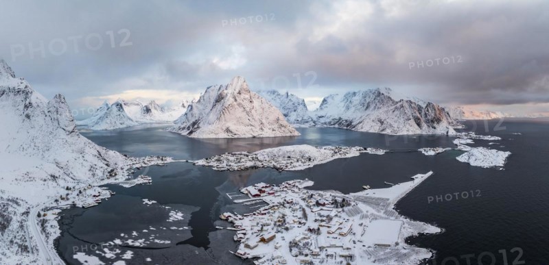 View of snow-covered islands, fjord and mountains, fishing villages Sakrisøy and Reine, Reinefjord, Lofoten, Norway, Europe