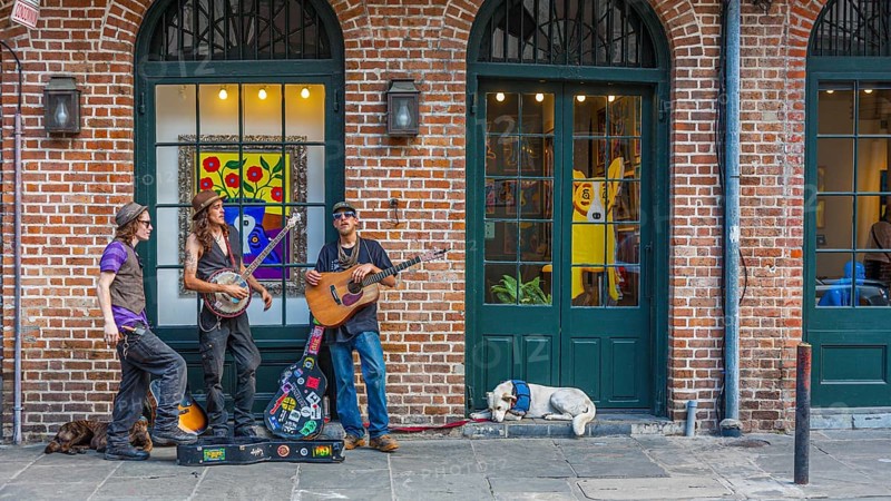 Street performers playing music on sidewalk in the French Quarter of New Orleans, Louisiana, USA, North America