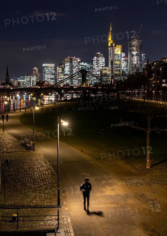 Skyline of the city centre of Frankfurt am Main, joggers on the pavement, promenade along the river Main, Weseler Werft, dusk, Hesse, Germany, Europe