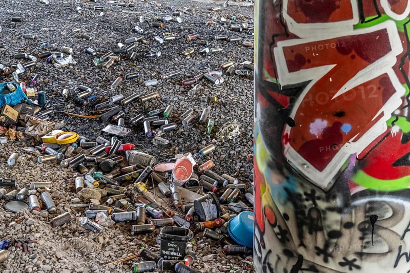 Empty spray paint cans, on a railway line below a road bridge, thrown away, disposed of by the sprayer, graffiti, rubbish heap, Essen, North Rhine-Westphalia, Germany, Europe