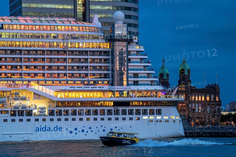 Cruise ship Aida Prima at the Cruise Terminal of Rotterdam, Kop van Zuid, skyscrapers at the Wilhelminakade, Hotel New York building, water taxi, Netherlands