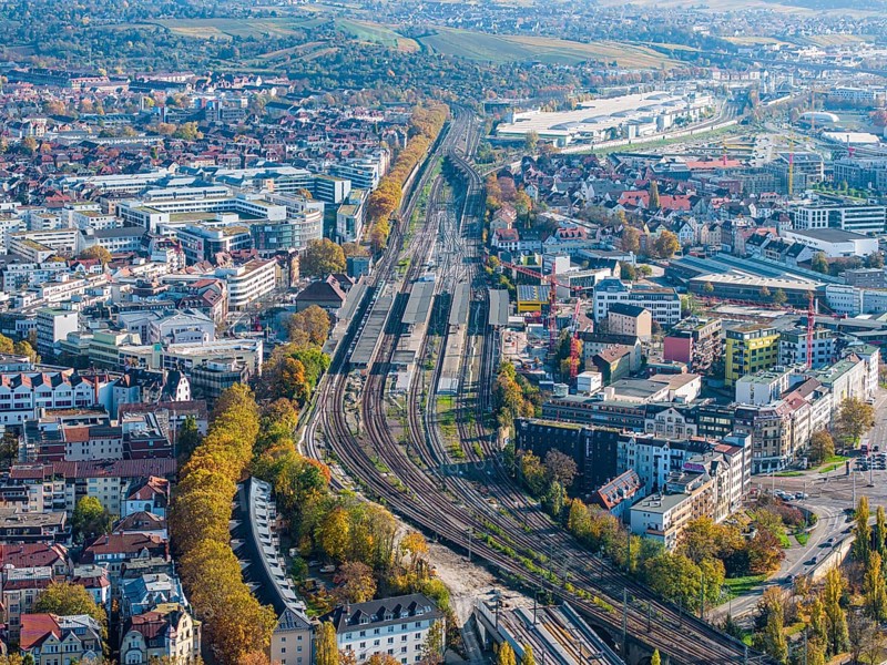 Stuttgart Bad Cannstatt with railway station, aerial view. Above it the Mercedes-Benz engine plant Cannstatt and vineyards. Stuttgart, Baden-Württemberg, Germany, Europe