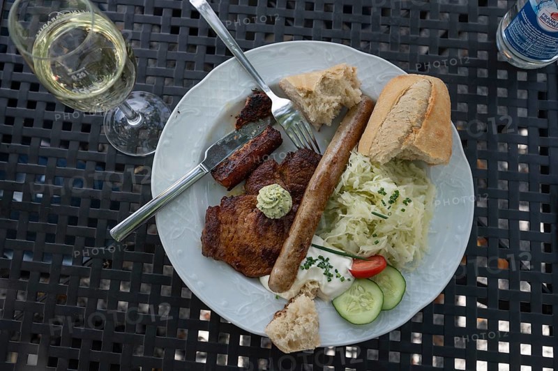 Steaks and bratwurst with coleslaw and quark served in a garden pub, Bavaria, Germany, Europe