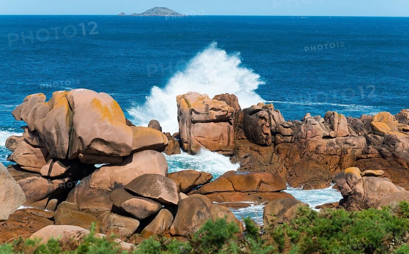 Rock formations in the sea with foaming waves under a blue sky, Ploumanac'h, Ploumanach, Perros-Guirec, Côtes-d'Armor, Brittany, France, Europe