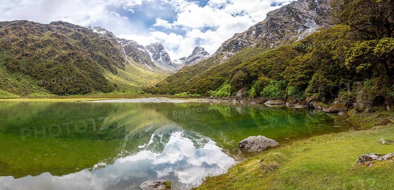 Tranquil mountain lake Mackenzie at the famous Routeburn Track, Fiordland National Park, South Island of New Zealand