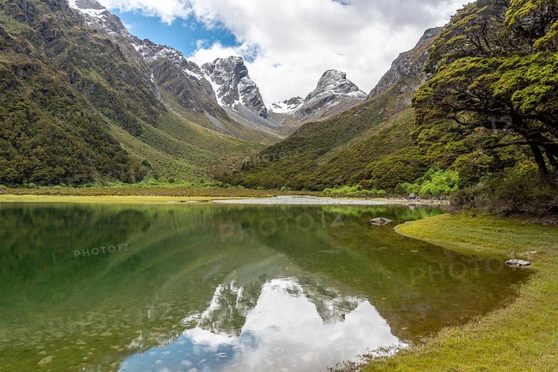 Tranquil mountain lake Mackenzie at the famous Routeburn Track, Fiordland National Park, South Island of New Zealand