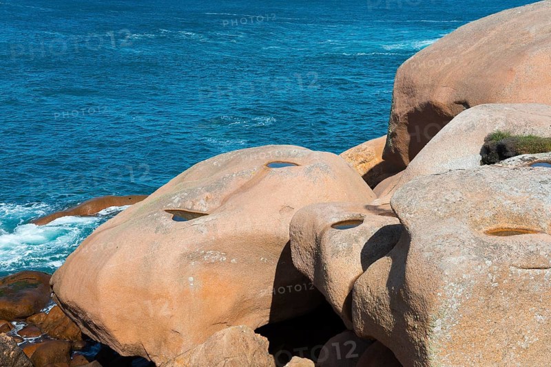 Close-up of jagged rocks with a view of the blue water, Ploumanac'h, Ploumanach, Perros-Guirec, Côtes-d'Armor, Brittany, France, Europe