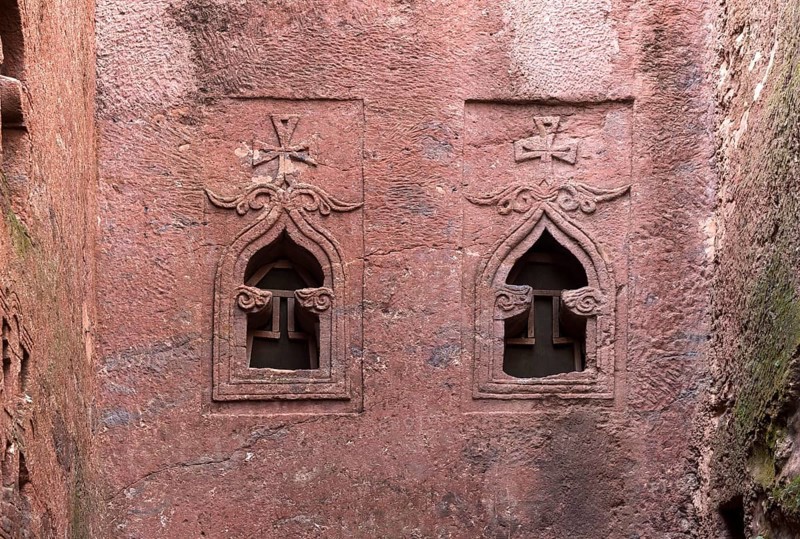 Pointed arch-shaped stone windows on the façade of the rock-hewn church of Biete Golgotha and Mikael, UNESCO World Heritage Site Lalibela, Ethiopia, Africa