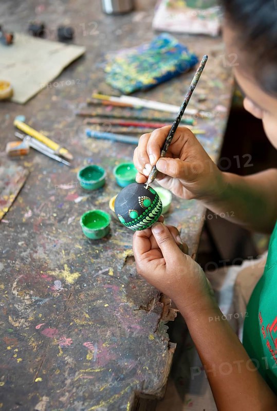 Sri Lankan woman painting a wooden ball, Oak Ray Woodcarvings, Naula, Matale, Central Province, Sri Lanka, Asia