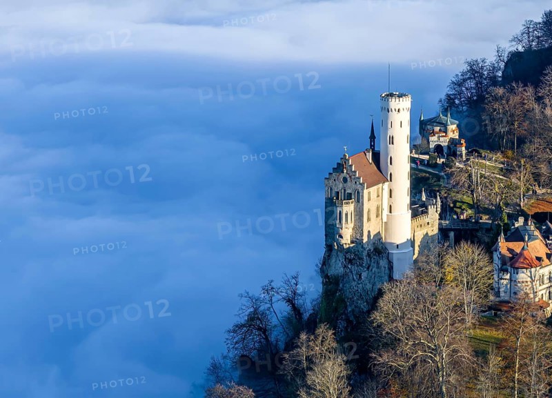 Sunshine in the mountains, fog in the Echaz valley. Lichtenstein Castle in the Swabian Alb. The fairytale castle of Württemberg is a 19th century castle built in the historicist style. Aerial photo. Lichtenstein, Baden-Württemberg, Germany, Europe
