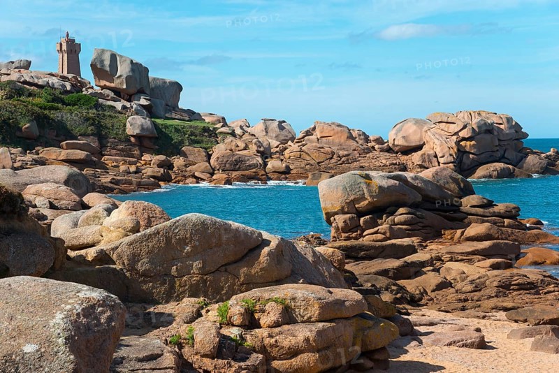 Rocky coast with lighthouse and blue sky in the background, Phare de Men Ruz, Ploumanac'h, Ploumanach, Perros-Guirec, Côtes-d'Armor, Brittany, France, Europe