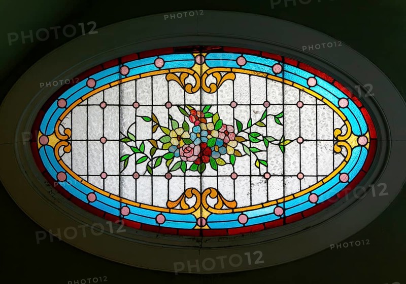 Stained glass oval window inside Casa Molina, Museo de Arte Popular de Yucatan, Merida, Mexico, Central America