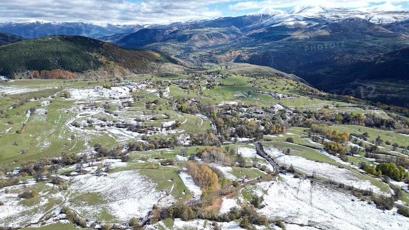 Aerial view of snow-patched fields surrounded by mountains and clouds. Posof, Ardahan, TURKEY